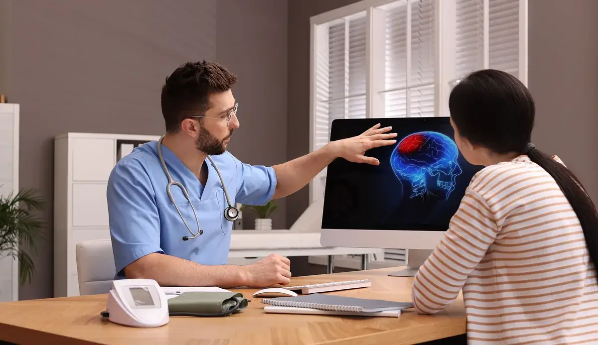 neurologist examining patient brain scan